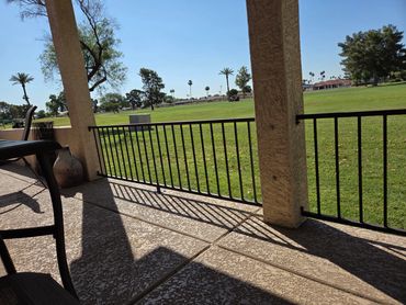 Wrought iron view fence with black powder-coated finish overlooking golf course. Sun City, Arizona. 