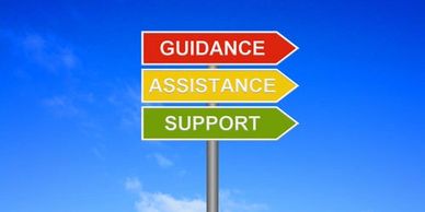 Colorful directional signs point to guidance, assistance, and support against a clear blue sky.