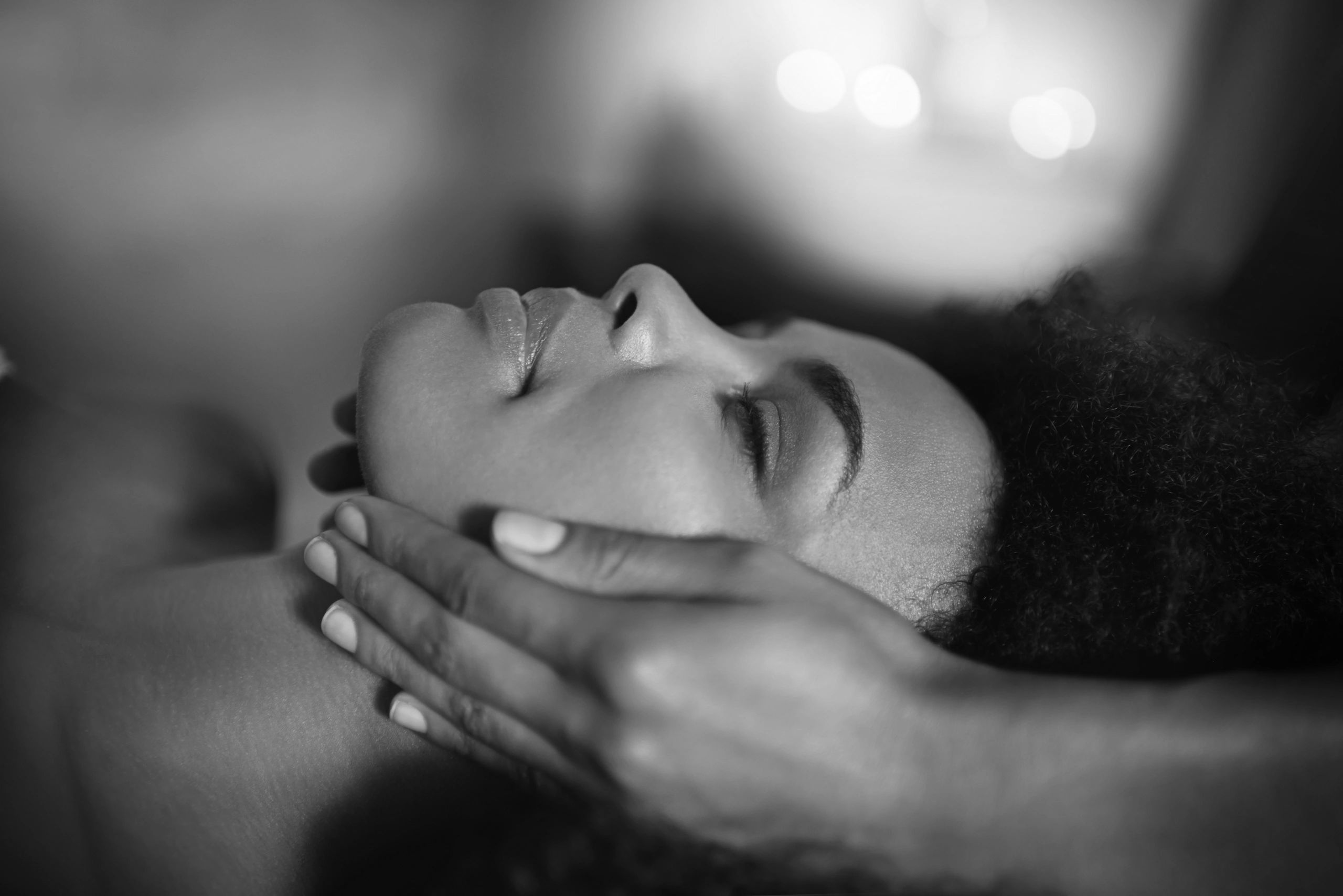 Relaxed woman getting a face massage.