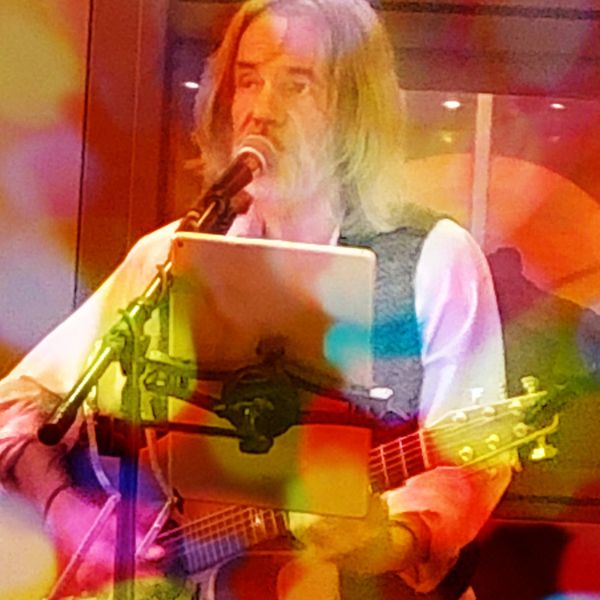 David Rosenblad playing guitar live with color spots
