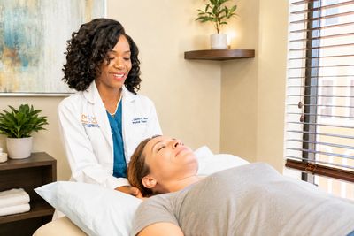 Dr. Dei providing gentle neck treatment to a patient at her Orlando physical therapy clinic.