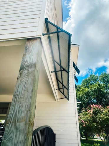 Custom black metal awnings on Texas coastal home. 24-gauge Galvalume® steel with Kynar® finish.