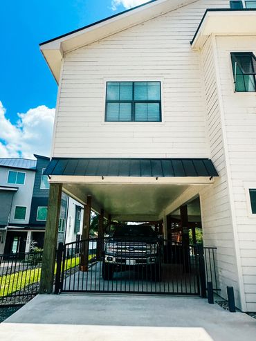 Custom black metal awnings on Texas coastal home. 24-gauge Galvalume® steel with Kynar® finish.