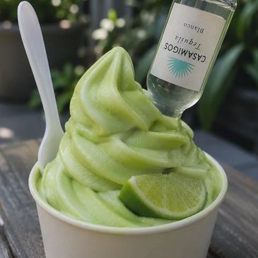 Green soft serve with a lime wedge and a tequila bottle.