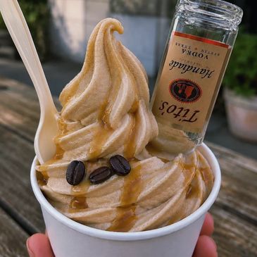 Coffee-flavored soft serve with coffee beans and a vodka mini bottle.