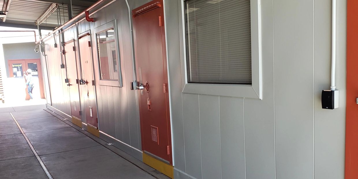 Commercial Painting job features orange walls and white doors.  done by Painting solutions AZ