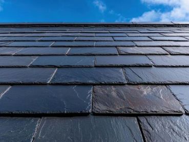 Slate roof with new ridge tiles 