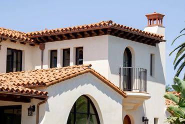 Mediterranean-style house with terracotta roof tiles.