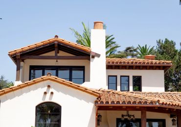 Modern home with terracotta roof and white walls.