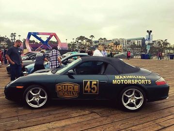 Black and gold Porsche with the Maximilian Motorsports logo on the rear fender.