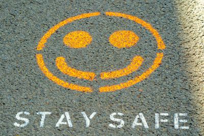 "Stay Save" image on sidewalk