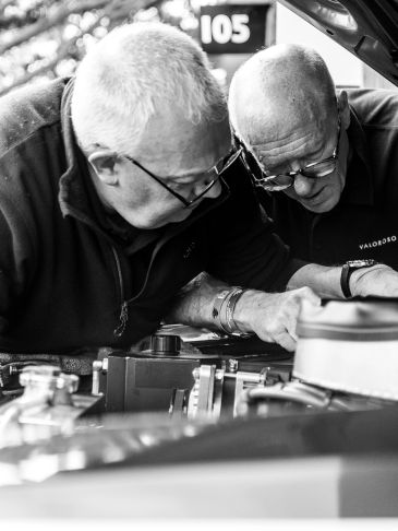 Mechanics taking care to look after and maintain a classic car. 