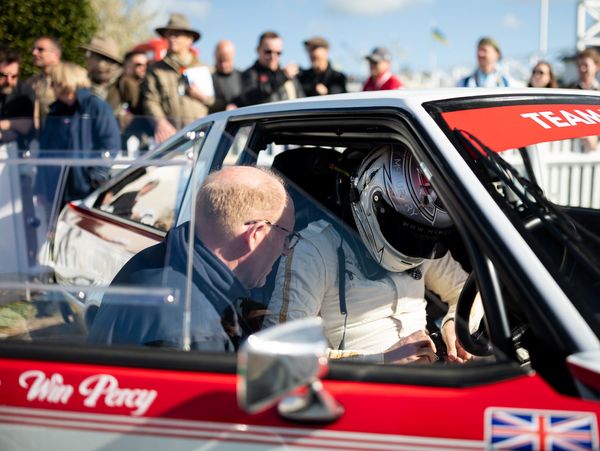 Max Chilton being strapped into a classic racing car, that Valoroso prepared & supported, at the Goo