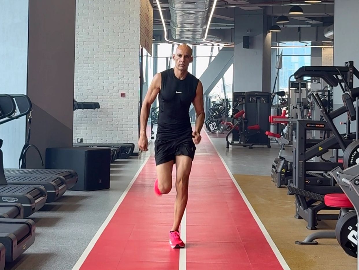 Manish Yadav is running on gym track.