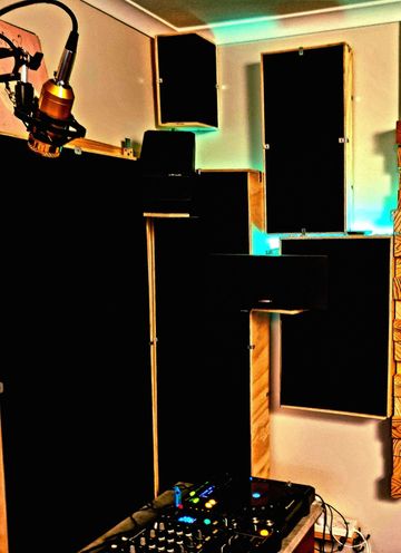 Recording studio corner with microphone and sound panels.