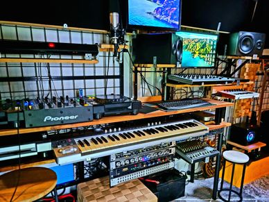 A modern music studio with various instruments and equipment.