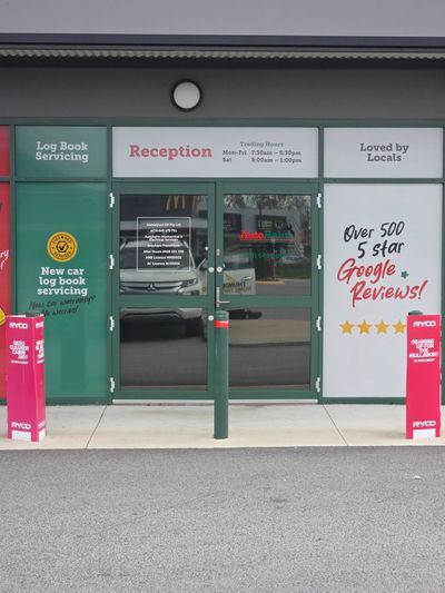 Entrance to an auto service reception with signage.