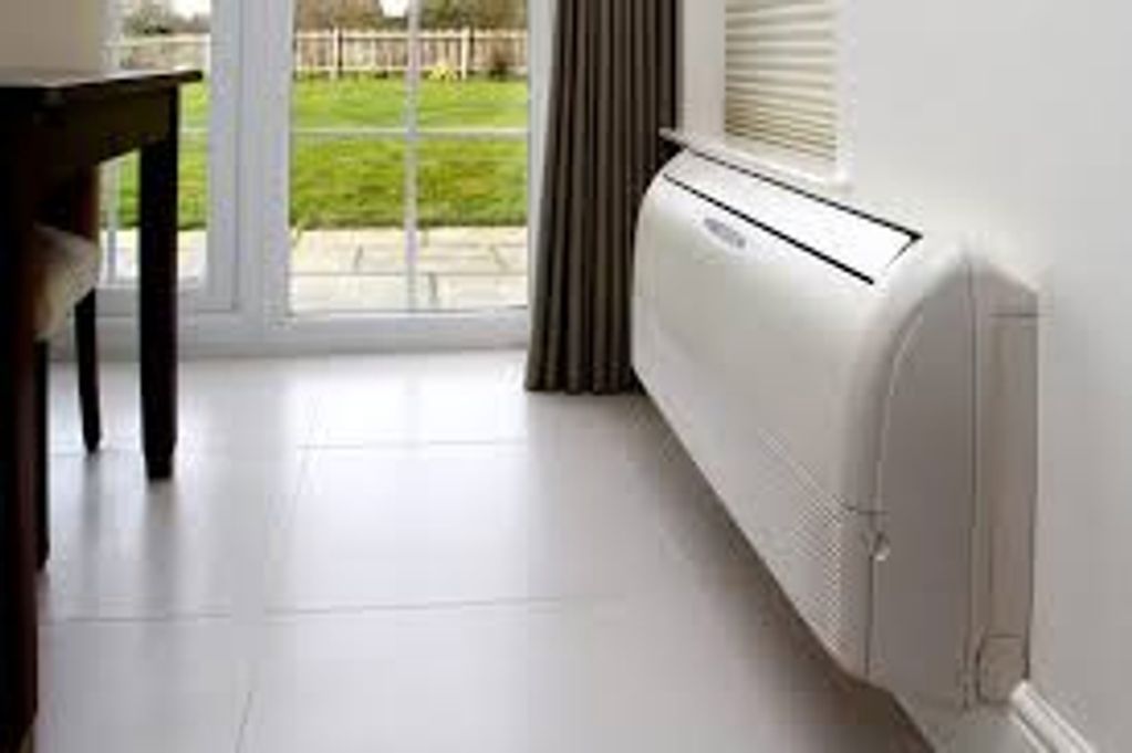 Modern wall-mounted air conditioner in a bright room.