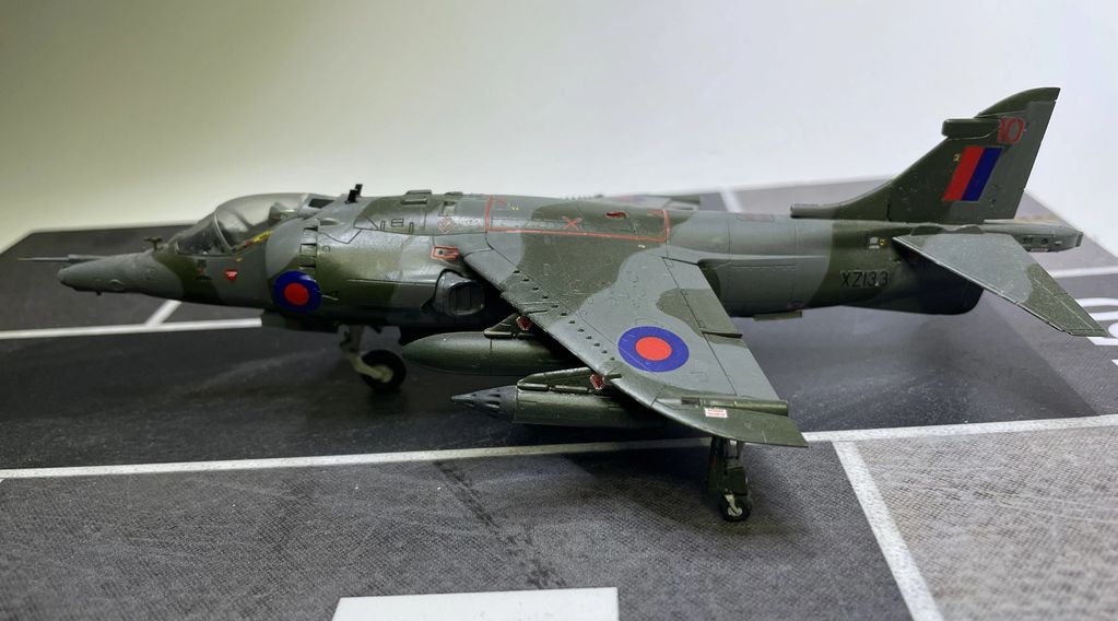 Model of a British military jet with camouflage paint and roundels.