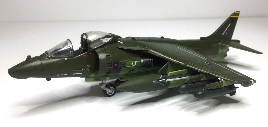Model of a military jet aircraft with green camouflage and detailed markings.