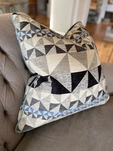 Bespoke geometric scatter cushion with contrast piping