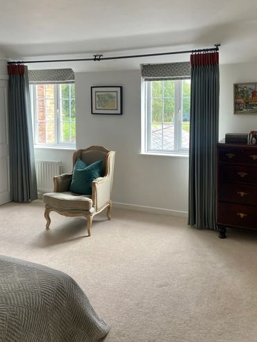 Traditional triple pleat grey curtains with burnt orange velvet pleat detail