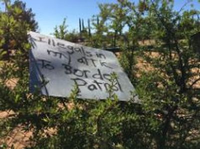 Illegals in my Attic text writing on a tent cover