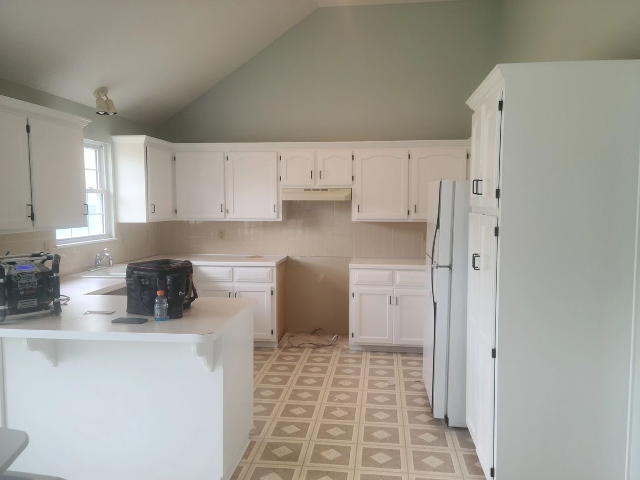 Freshly painted cabinets brighten the whole area.