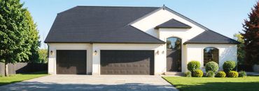 Modern suburban house with a large driveway and three-car garage.