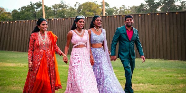 Indian family walking in grass