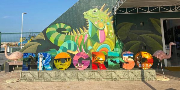 Iguana mural and Progreso destination sign in Progreso, Mexico