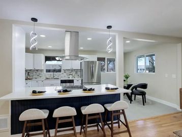 Modern residential kitchen with new electrical wiring and lighting installed during construction