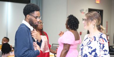 Two people engaged in a conversation at a social event.