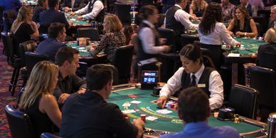 People playing cards at a casino table.