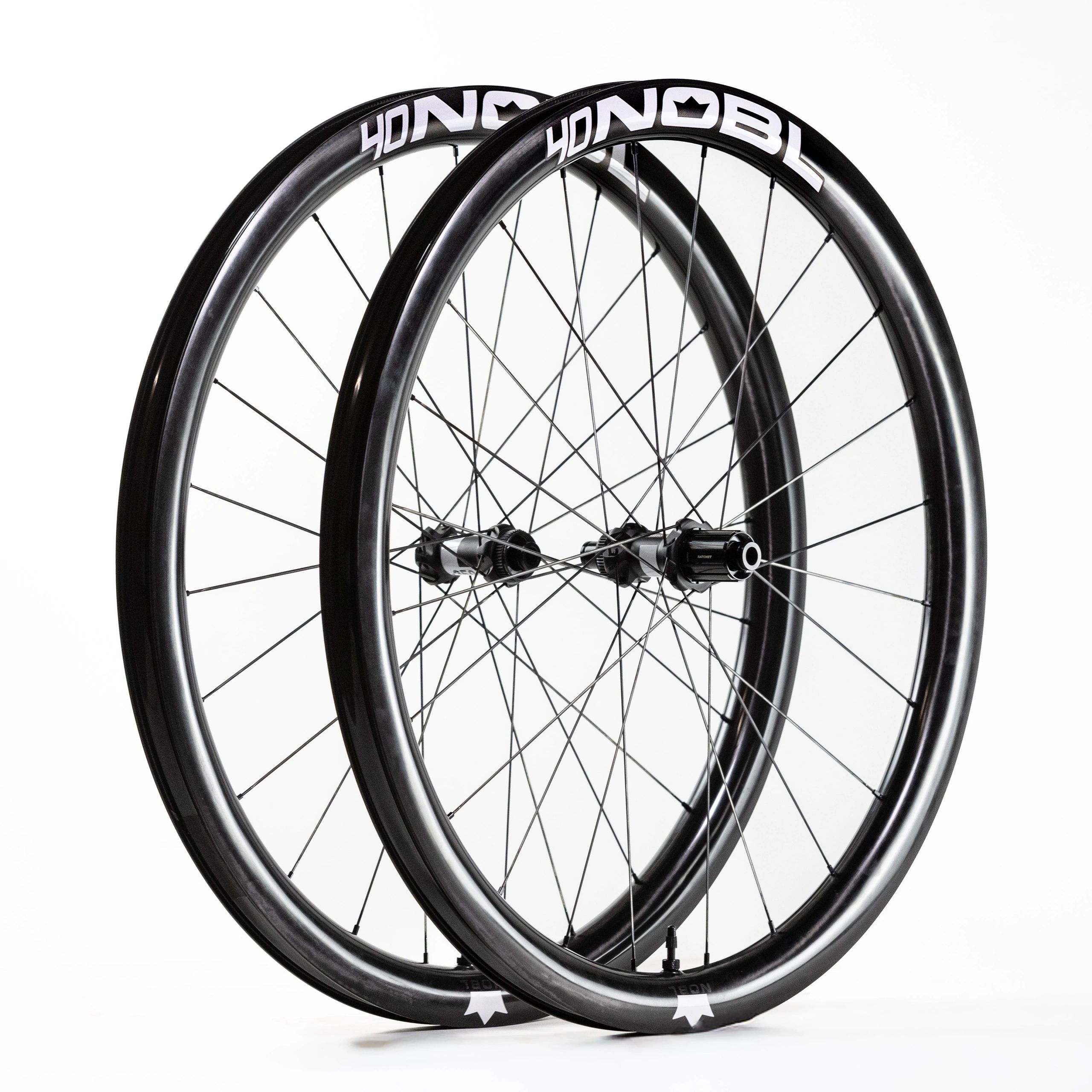 Pair of sleek black carbon bike wheels with white Nobl branding.