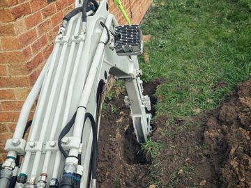 Digging a test hole to expose existing foundation for extension.