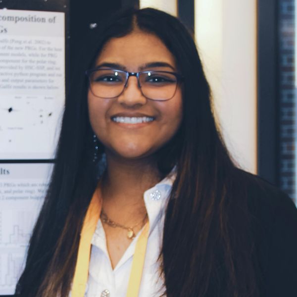 Smiling woman with glasses at a presentation.
