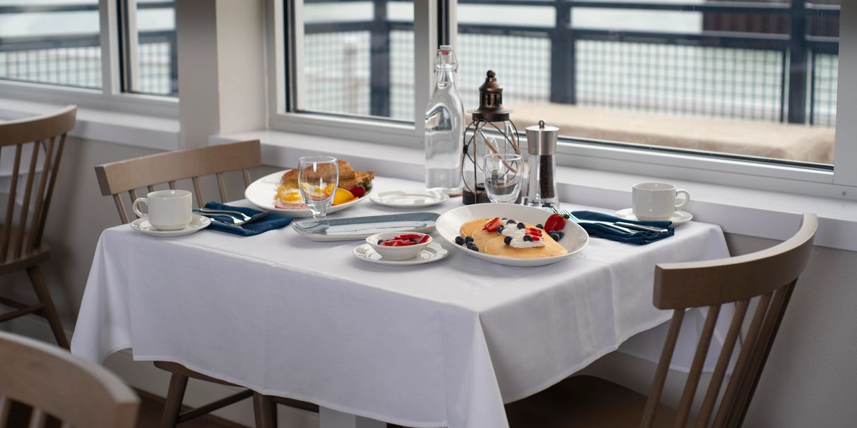 Breakfast served on table overlooking Lake Michigan