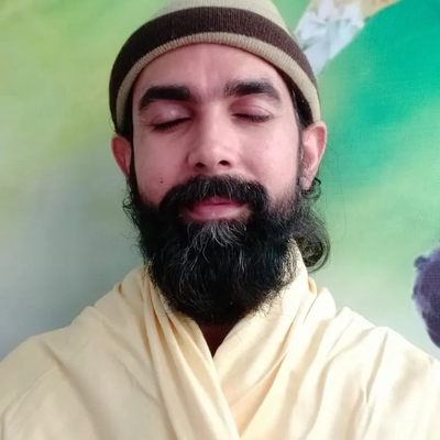 Man with closed eyes and beard meditating peacefully.