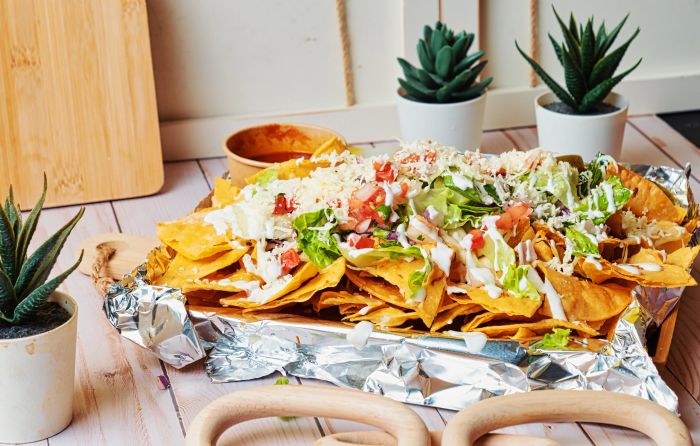 Nachos smothered in Monterey Jack cheese with pico de gallo and guacamole.
