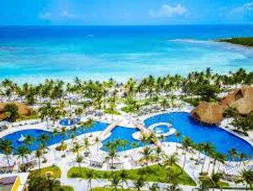 A tropical resort with pools by the ocean.