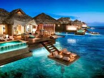Luxurious overwater bungalows with private pools at sunset.