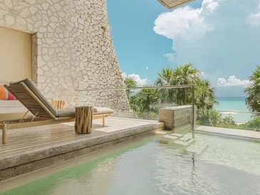 Oceanview hotel balcony with pool and lounger