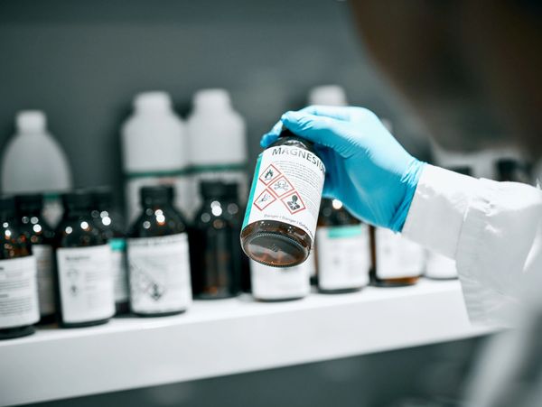 Expert analyzing digital reports with bold Prop 65 warning sign