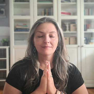 Aneta meditating, hands in prayer