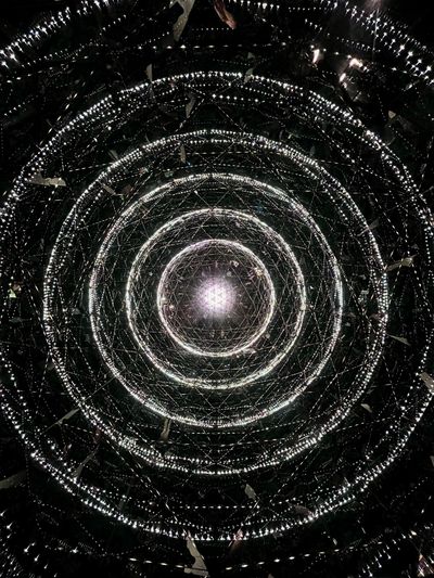 Concentric rings of glowing lights create a mesmerizing tunnel effect.