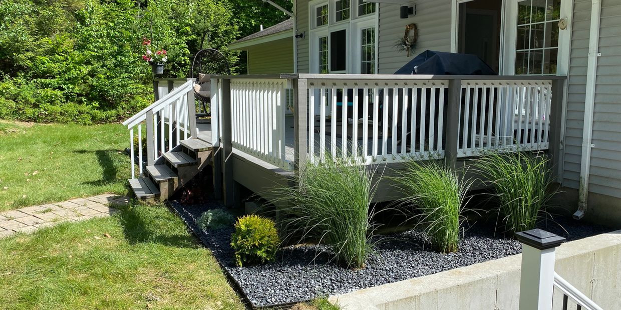 plant install with aluminum edging to separate gravel from grass
