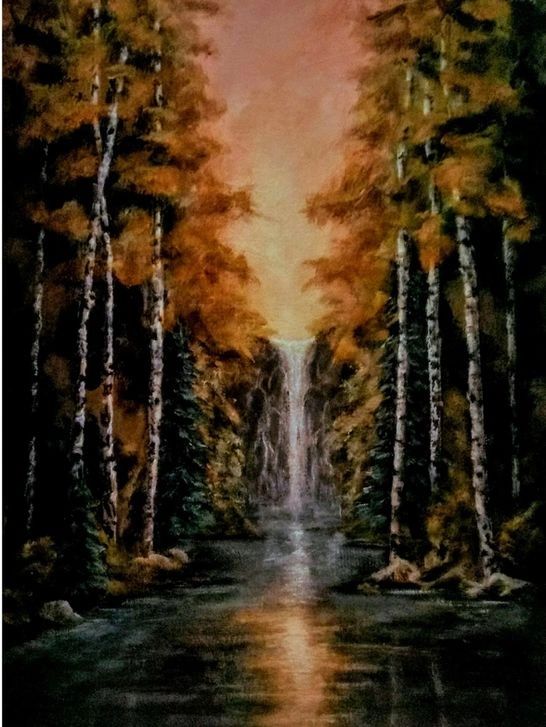 Waterfall in an autumn forest at sunset.