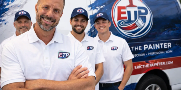 Four painters in white ETP shirts posing in front of a branded van.