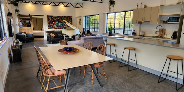 Spacious modern living room with dining area and kitchen.